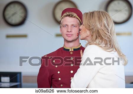 Older woman kissing bellhop's cheek View Large Photo Image Stock Photograph - Older woman kissing bellhop's cheek. Fotosearch