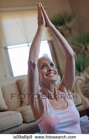Older woman practicing yoga at home View Large Photo Image Stock Photo - Older woman practicing yoga at home. Fotosearch