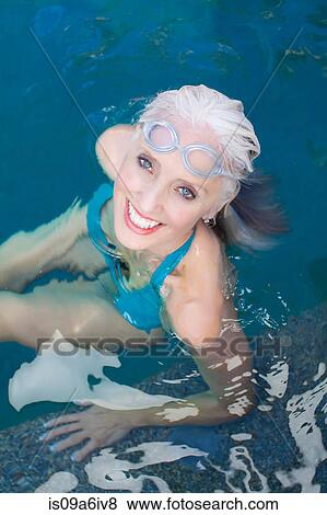 Older woman swimming in pool View Large Photo Image Stock Photo - Older woman swimming in pool. Fotosearch