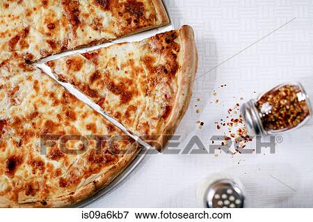 Stock Photo - Pizza slice with spilled chili flakes. Fotosearch