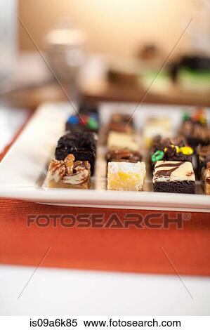 Plate of decorated desserts on table View Large Photo Image Stock Photography - Plate of decorated desserts on table. Fotosearch