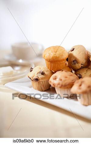 Stock Image - Plate of muffins on table. Fotosearch