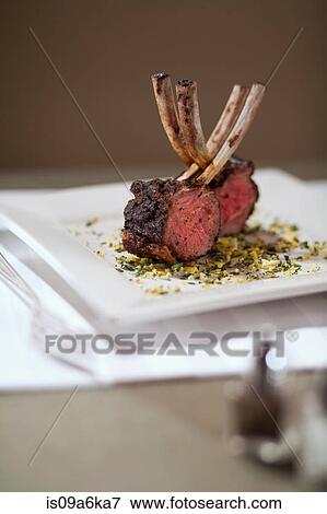 Plate of roast lamb on table View Large Photo Image Stock Photo - Plate of roast lamb on table. Fotosearch