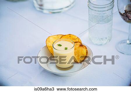 Stock Image - Plate of soup with potato chips. Fotosearch