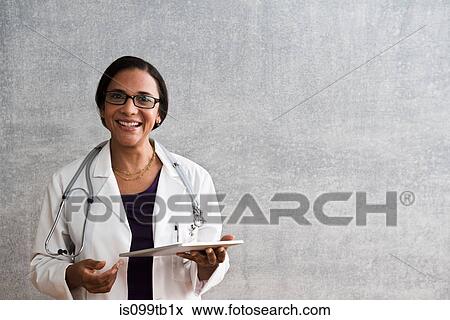 Portrait of a female doctor with digital tablet View Large Photo Image Stock Photo - Portrait of a female doctor with digital tablet. Fotosearch