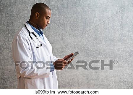 Picture - Portrait of male doctor with digital tablet. Fotosearch