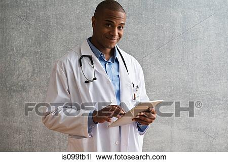 Portrait of male doctor with digital tablet View Large Photo Image Stock Image - Portrait of male doctor with digital tablet. Fotosearch