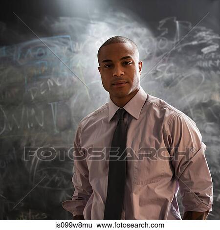 Portrait of man in front of blackboard View Large Photo Image Stock Photograph - Portrait of man in front of blackboard. Fotosearch