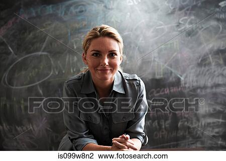 Portrait of woman in front of blackboard View Large Photo Image Stock Image - Portrait of woman in front of blackboard. Fotosearch