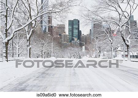 Stock Image - Road in snowy urban park. Fotosearch
