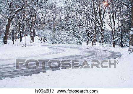 Stock Photo - Road in snowy urban park. Fotosearch