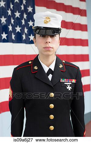 Stock Photo - Servicewoman in dress blues by US flag. Fotosearch