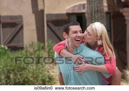 Smiling couple hugging outdoors View Large Photo Image Stock Image - Smiling couple hugging outdoors. Fotosearch