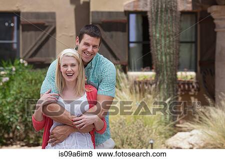 Smiling couple hugging outdoors View Large Photo Image Stock Photo - Smiling couple hugging outdoors. Fotosearch
