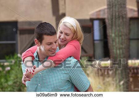 Smiling couple hugging outdoors View Large Photo Image Stock Photo - Smiling couple hugging outdoors. Fotosearch