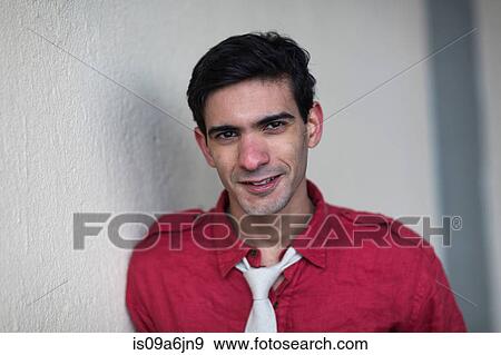 Stock Photo - Smiling man leaning on wall. Fotosearch