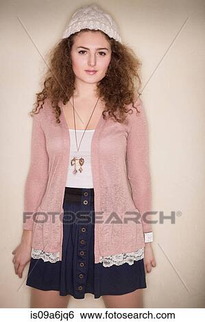 Smiling woman leaning on wall View Large Photo Image Stock Photograph - Smiling woman leaning on wall. Fotosearch