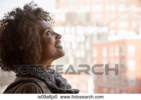 Smiling woman standing at window View Large Photo Image Stock Image - Smiling woman standing at window. Fotosearch