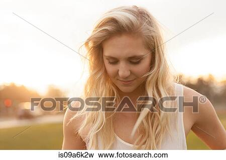Stock Photo - Smiling woman standing in field. Fotosearch