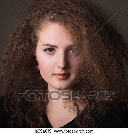 Stock Photo - Smiling woman with curly hair. Fotosearch