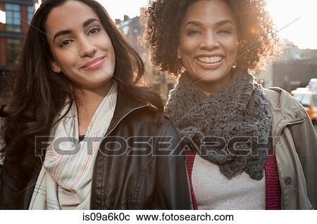 Smiling women on city street View Large Photo Image Stock Image - Smiling women on city street. Fotosearch