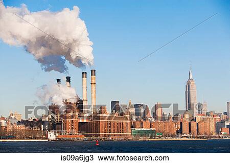 Stock Image - Smoke billowing from industrial plant. Fotosearch