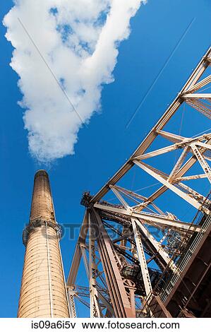 Smoke billowing from industrial plant View Large Photo Image Stock Photo - Smoke billowing from industrial plant. Fotosearch