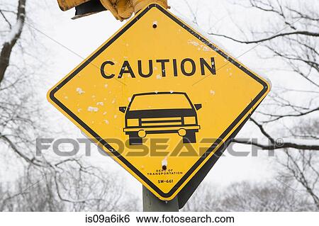 Stock Photograph - Snowy 'caution' road sign. Fotosearch
