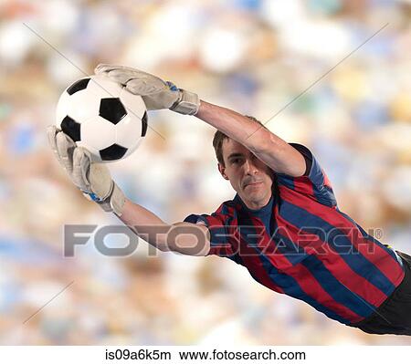 Picture - Soccer player catching ball in air. Fotosearch