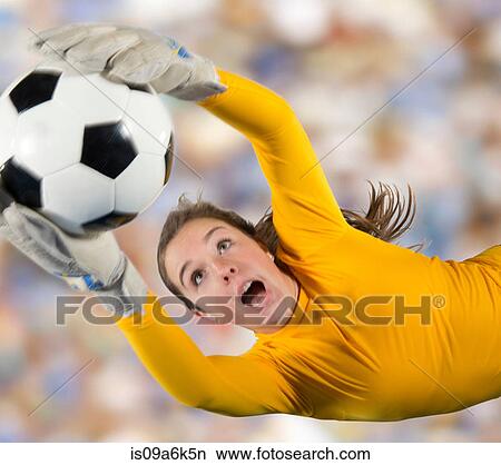 Soccer player catching ball in air View Large Photo Image Picture - Soccer player catching ball in air. Fotosearch