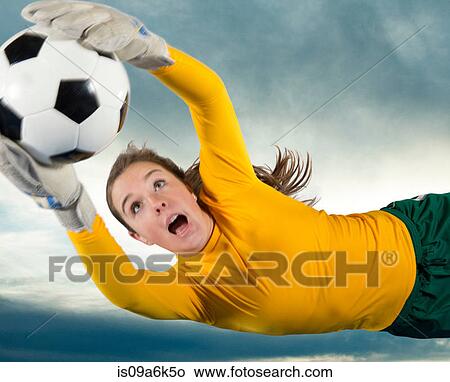 Picture - Soccer player catching ball in air. Fotosearch