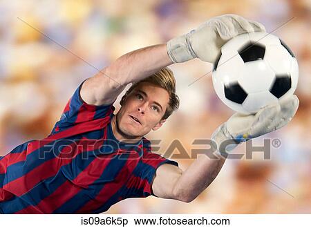Stock Photography - Soccer player catching ball in air. Fotosearch