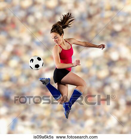 Soccer player kicking ball in air View Large Photo Image Stock Photograph - Soccer player kicking ball in air. Fotosearch