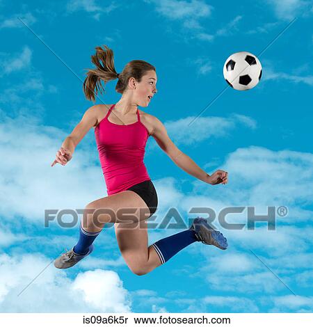 Soccer player kicking ball in air View Large Photo Image Stock Photography - Soccer player kicking ball in air. Fotosearch