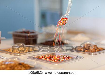 Sprinkles pouring from spoon in display View Large Photo Image Stock Photography - Sprinkles pouring from spoon in display. Fotosearch
