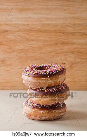 Stock Photo - Stack of decorated doughnuts. Fotosearch