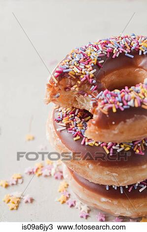 Stack of doughnuts with bite View Large Photo Image Stock Image - Stack of doughnuts with bite. Fotosearch
