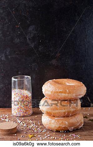 Stack of glazed donuts and sprinkles View Large Photo Image Stock Image - Stack of glazed donuts and sprinkles. Fotosearch