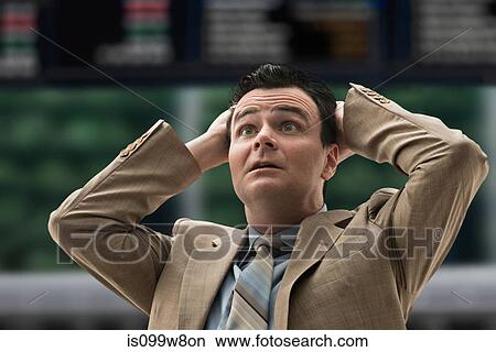 Picture - Stressed businessman at stock exchange. Fotosearch