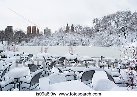 Tables and chairs in snowy urban park View Large Photo Image Stock Photo - Tables and chairs in snowy urban park. Fotosearch