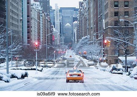 Stock Photo - Taxi on snowy city street. Fotosearch