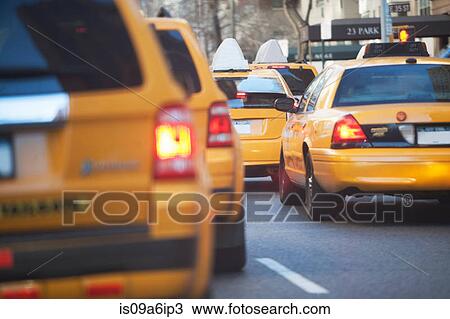 Stock Image - Taxis sitting in city traffic. Fotosearch