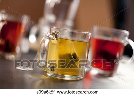 Stock Image - Tea bags steeping in glass mugs. Fotosearch