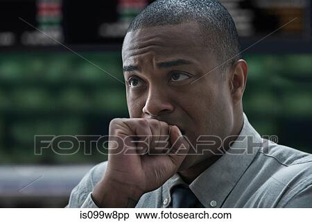 Stock Photography - Tense businessman at stock exchange. Fotosearch