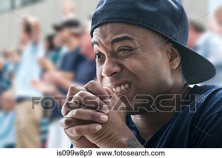 Tense man at sports game View Large Photo Image Stock Photo - Tense man at sports game. Fotosearch