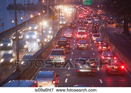 Stock Photo - Traffic on busy highway at twilight. Fotosearch