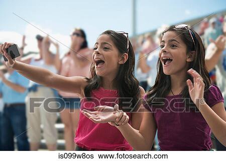 Two excited girls at a pop concert View Large Photo Image Stock Photograph - Two excited girls at a pop concert. Fotosearch