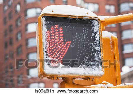 Picture - Walk sign on snowy city street. Fotosearch
