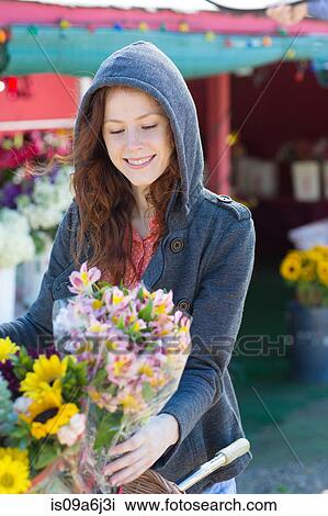 Woman buying flowers at florist View Large Photo Image Stock Image - Woman buying flowers at florist. Fotosearch