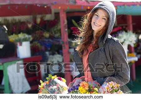 Woman buying flowers at florist View Large Photo Image Stock Image - Woman buying flowers at florist. Fotosearch